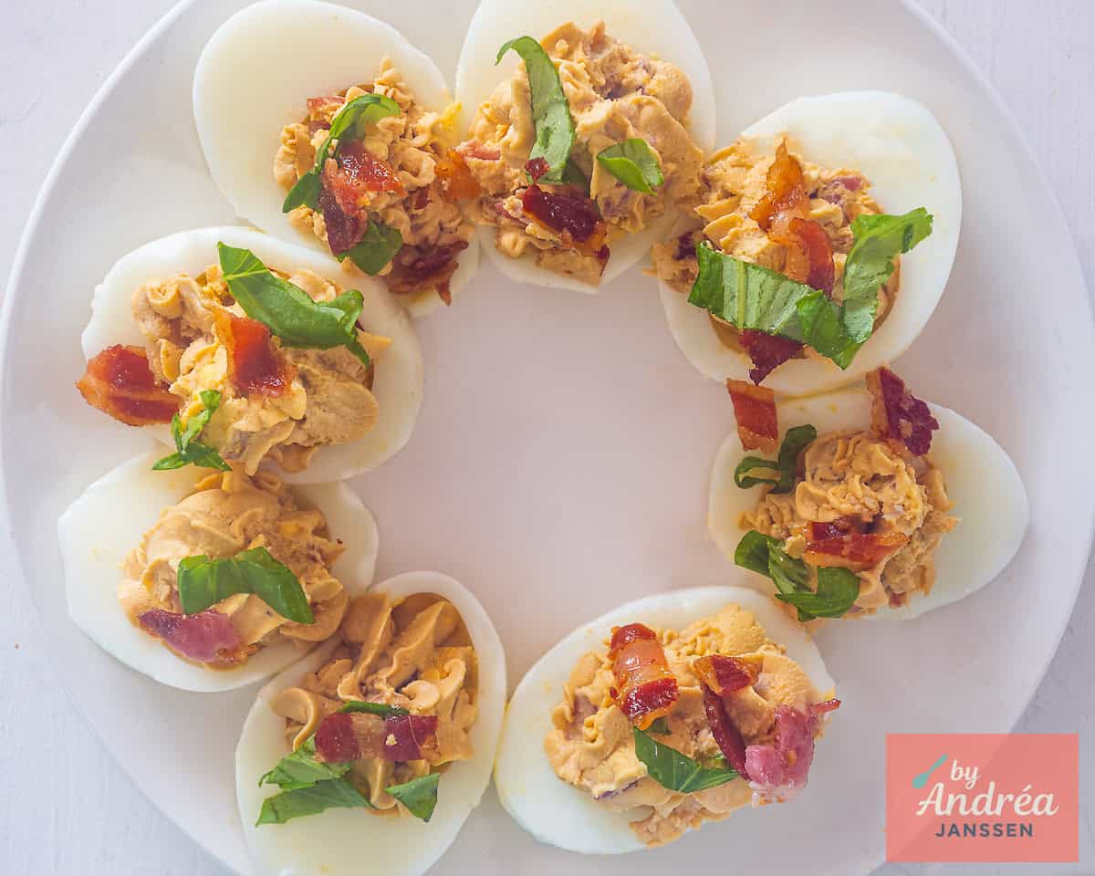 Garnish the eggs with pancetta and basil strips.