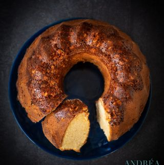 a turban cake with cashew nuts on a black plate