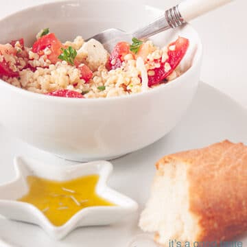A bowl with bulgur salad, a baguette and herb oil