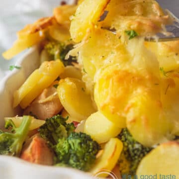 Chicken, bacon, broccoli and potato casserole in a white casserole dish