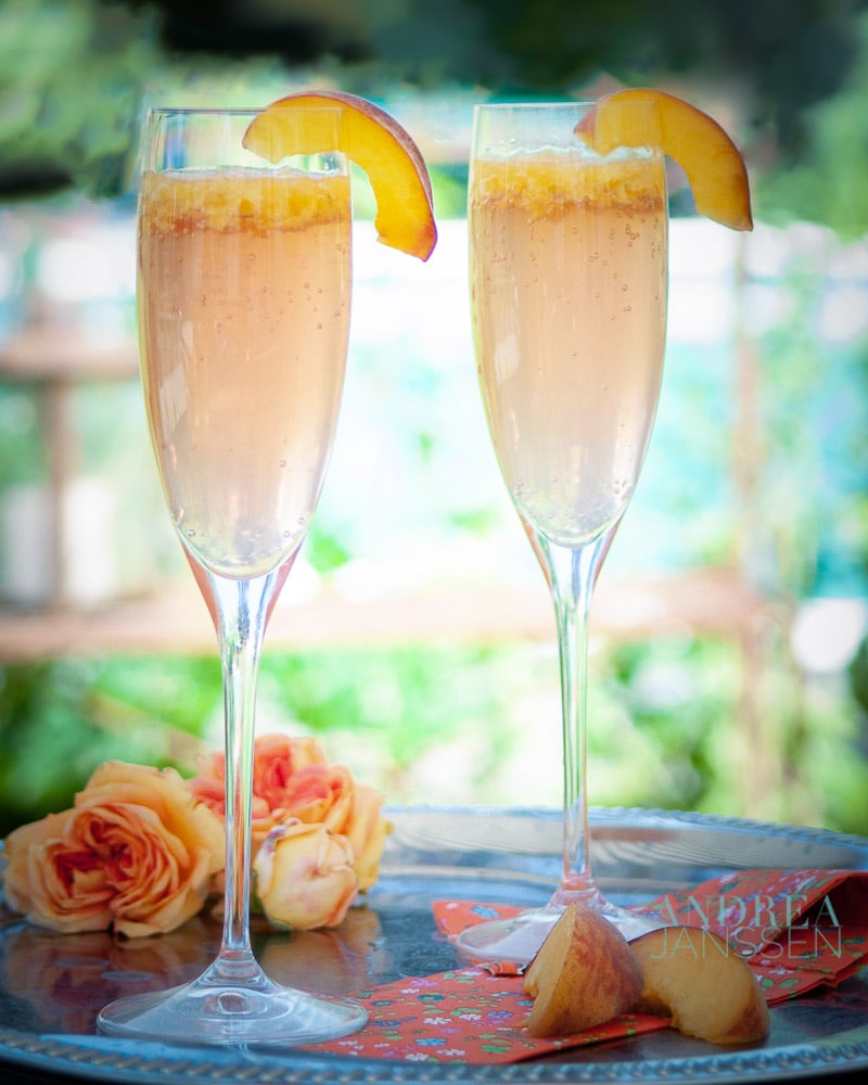 two glasses with Bellini cocktail and slices fresh peach