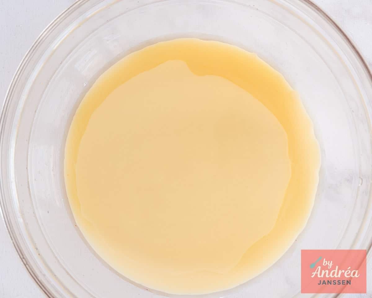 A glass bowl with honey, condensed milk, lime, and vanilla