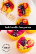 Two pictures with orange fruit bowls on top of each other. A text in between: fruit salad in orange cups