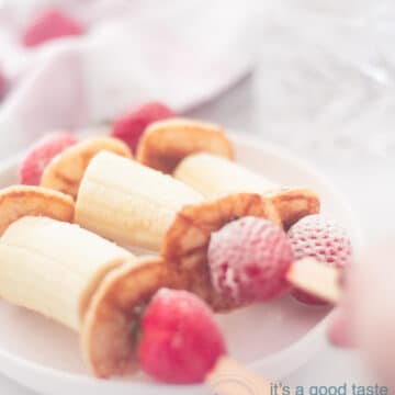 3 healthy treats with banana strawberries and pancakes on a stick on a plate