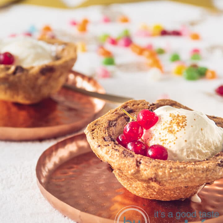 2 cookie baskets filled with vanilla ice cream and red berries