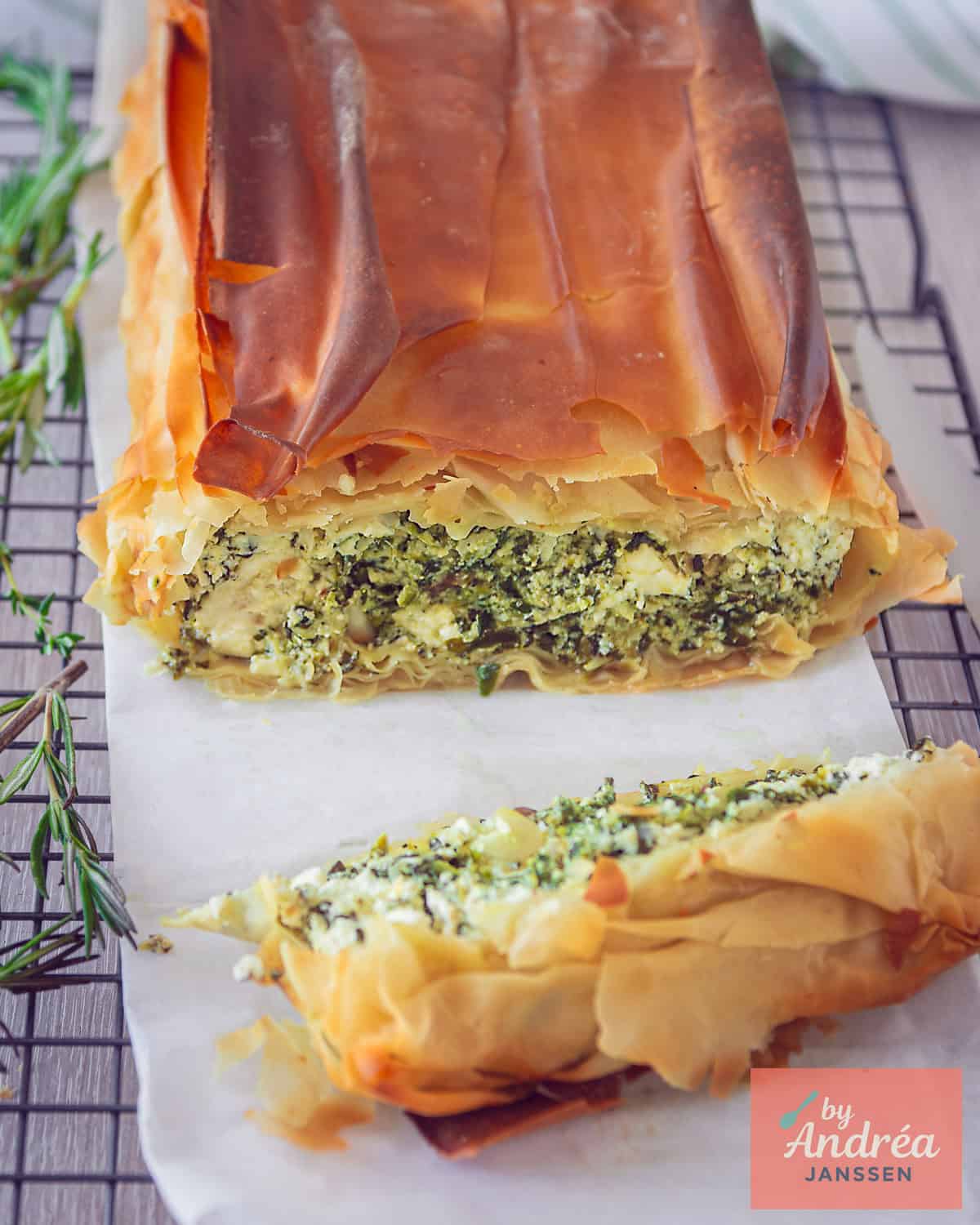 A quiche cut open to clearly see the spinach, feta and ricotta filling.