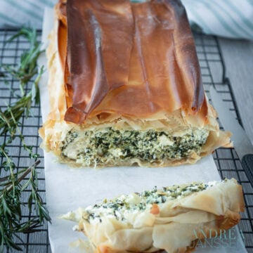 Spinach ricotta and feta cake on a baking paper and rack