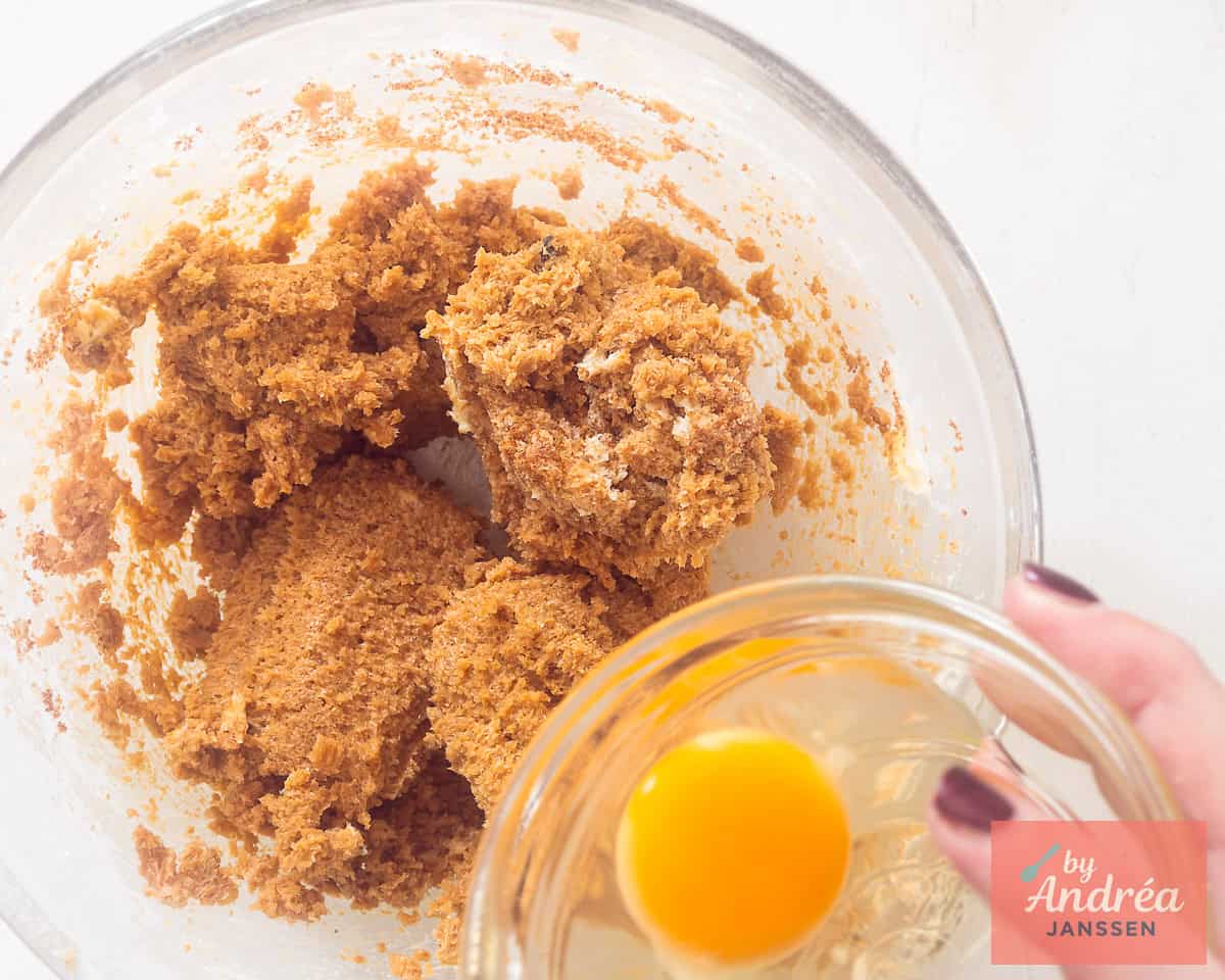Adding an egg to the cupcake batter