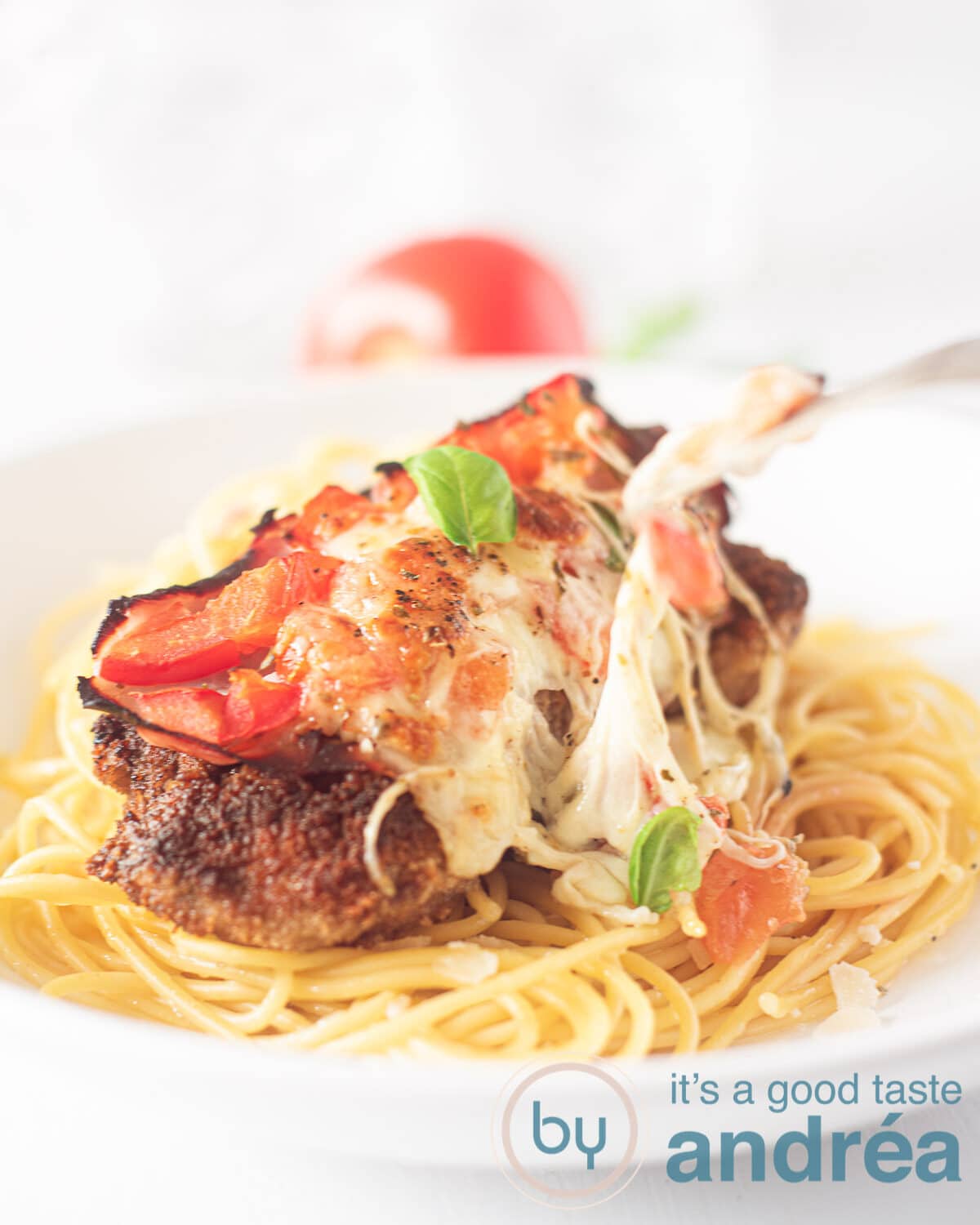 spaghetti topped with Milanesas napolitana