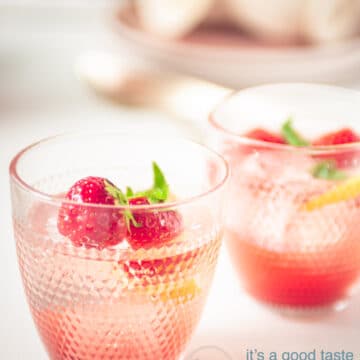 two glasses of strawberry lemonade with strawberry and lemon garnish