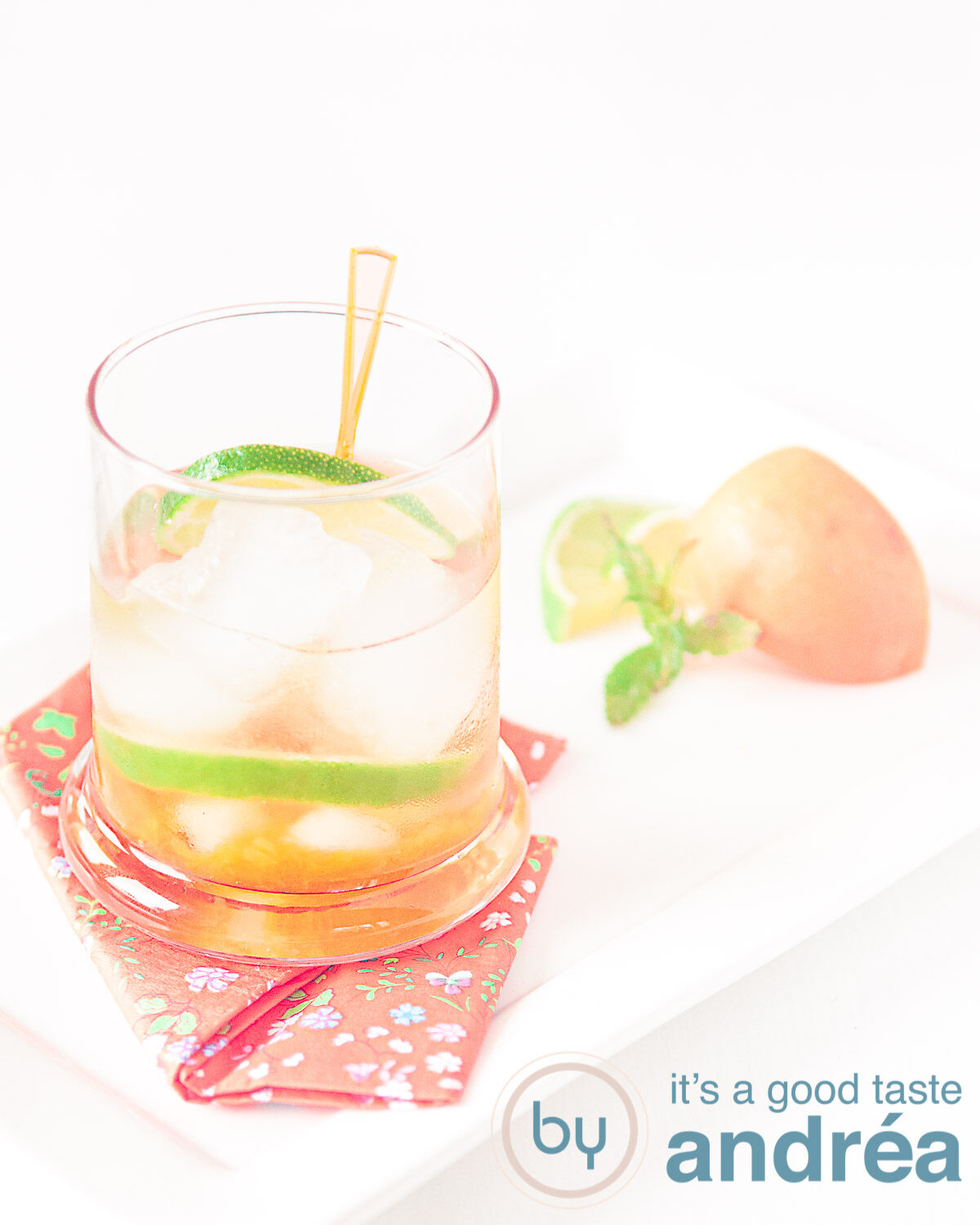 an Orange caipirinha with apricots in a cocktail glass and some garnish of apricots and lime