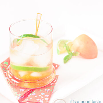 an Orange caipirinha with apricots in a cocktail glass and some garnish of apricots and lime