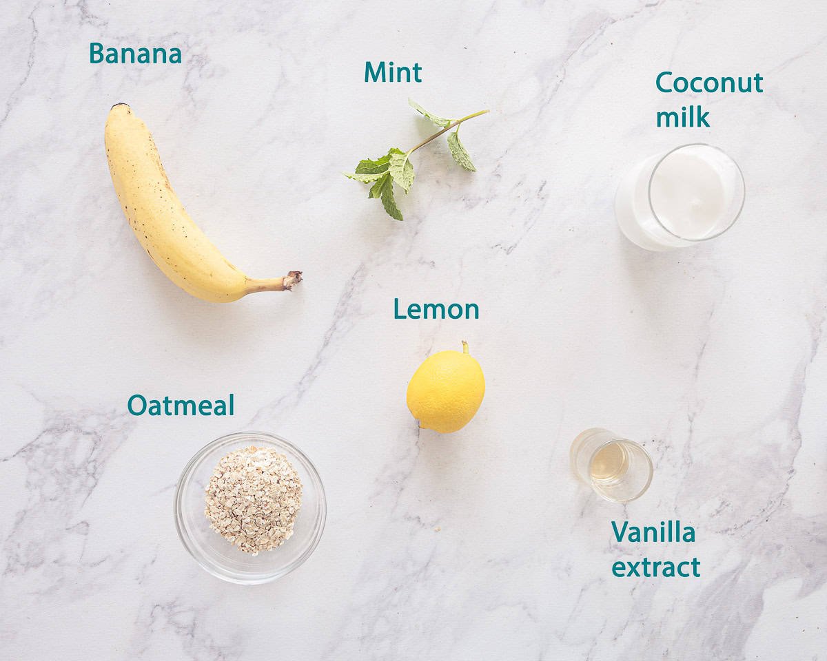 Ingredients Banana Oat Smoothie with Lemon on a marble background with text description