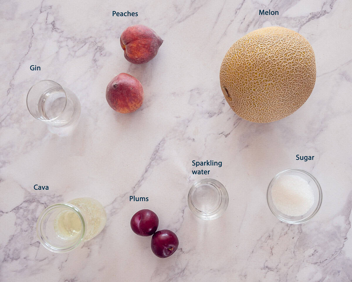 ingredients Sparkling Sangria Bianca on a marbled white background with text description