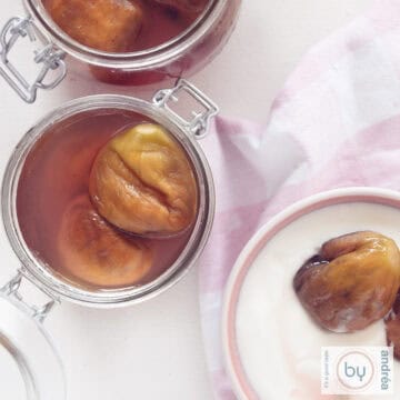 A square photo with two jars filled with figs in syrup, preserved on the left and a pink bowl with yogurt and figs in the bottom right.