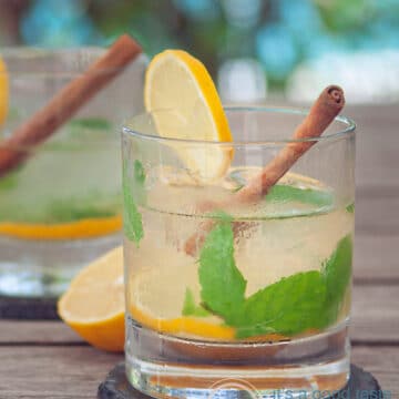A glass with Caipirinha with tea, lemon, ginger, int and cinnamon