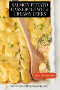Part of a casserole with salmon, leek and potato gratin. A text: salmon potato casserole with creamy leeks.