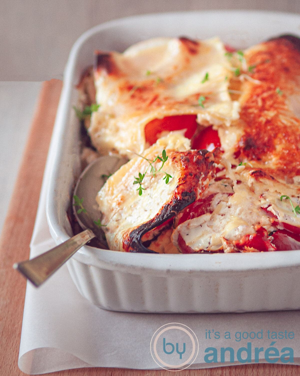 a vegetarian lasagna casserole with a spoon full taken