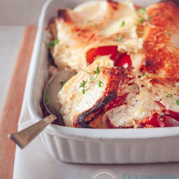 a vegetarian lasagna casserole with a spoon full taken
