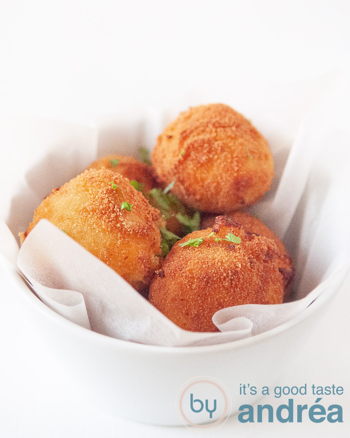 four cheese bitterballen in a white bowl
