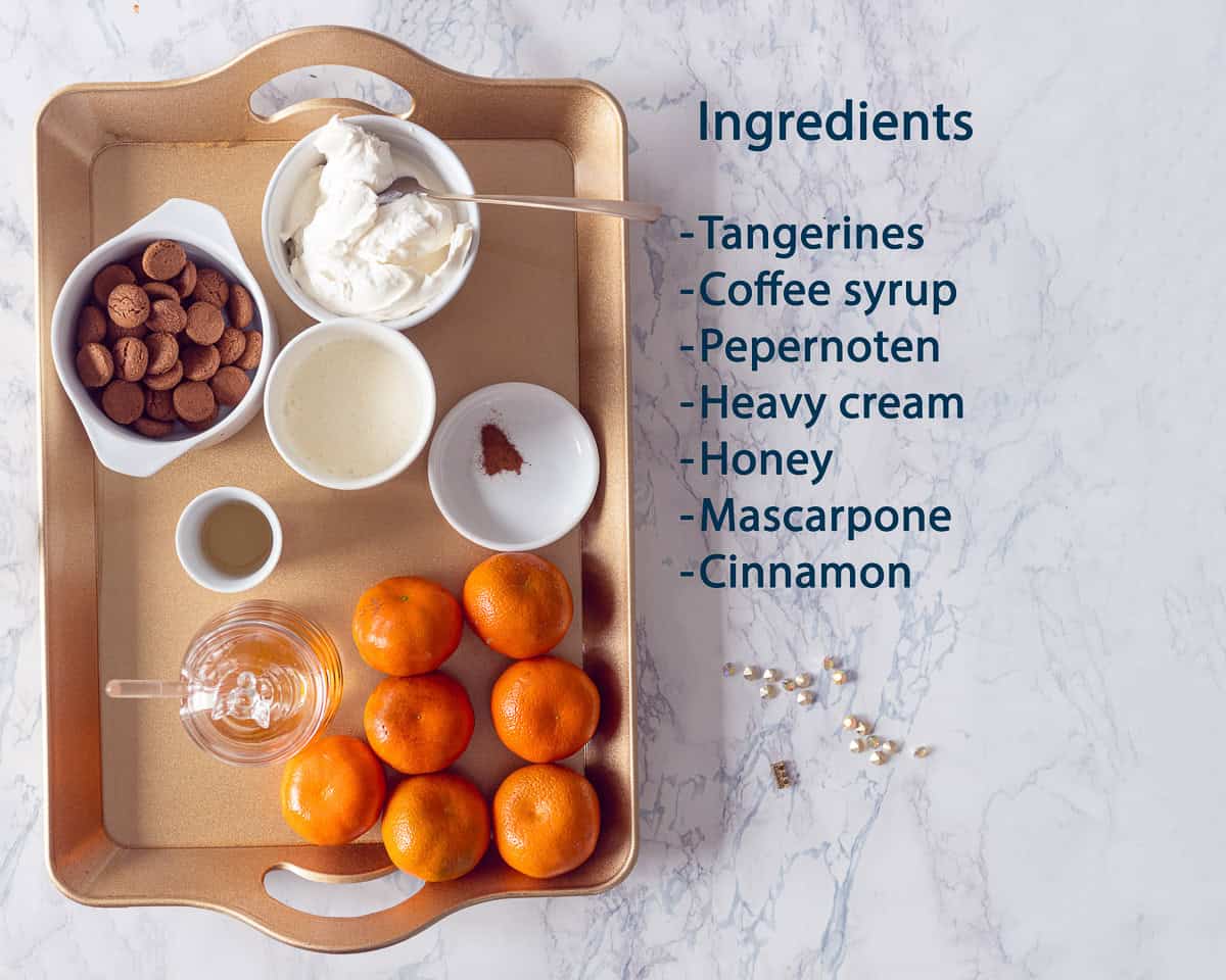 Ingredients for pepernoten Tiramisu with Kruidnoten on a golden tray with a text description.