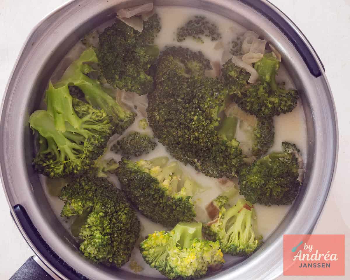 Broccoli with seasonings, potato, and milk in a saucepan