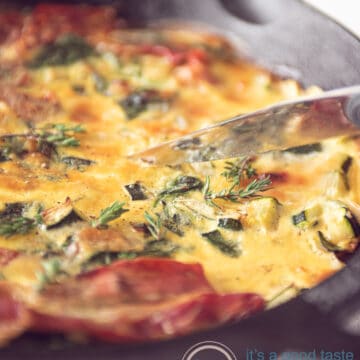 a pan with a frittata with spinach and zucchini