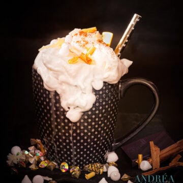 a cup of Hot chocolate with vanilla and herbal liquor with golden props