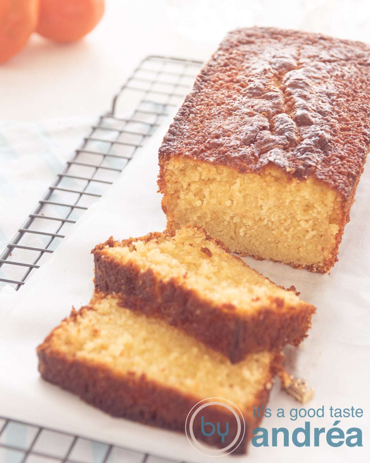 tangerine cake with slices on a rack, tangerines in the background