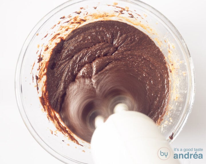 A mixer that mixes chocolate cookie batter.