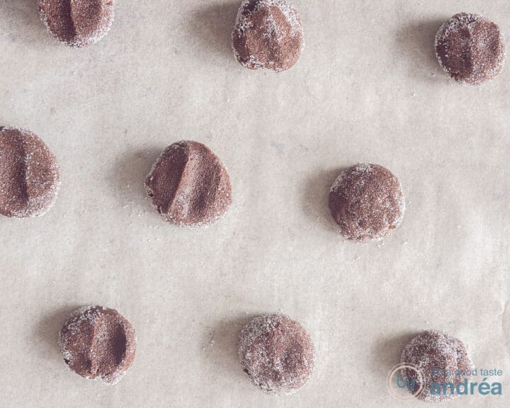 A baking sheet with chocolate chip cookie dough rolled in sugar