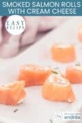 A portion of a long tray of salmon rolls filled with cream cheese. A text: easy recipe, Smoked Salmon Rolls with Cream Cheese