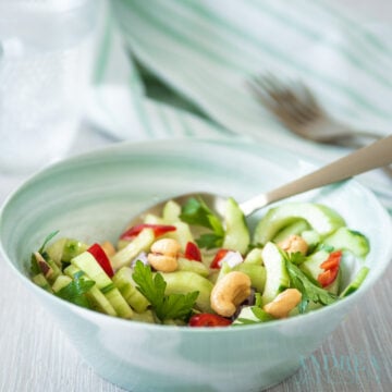 a green bowl with Spicy cucumber salad