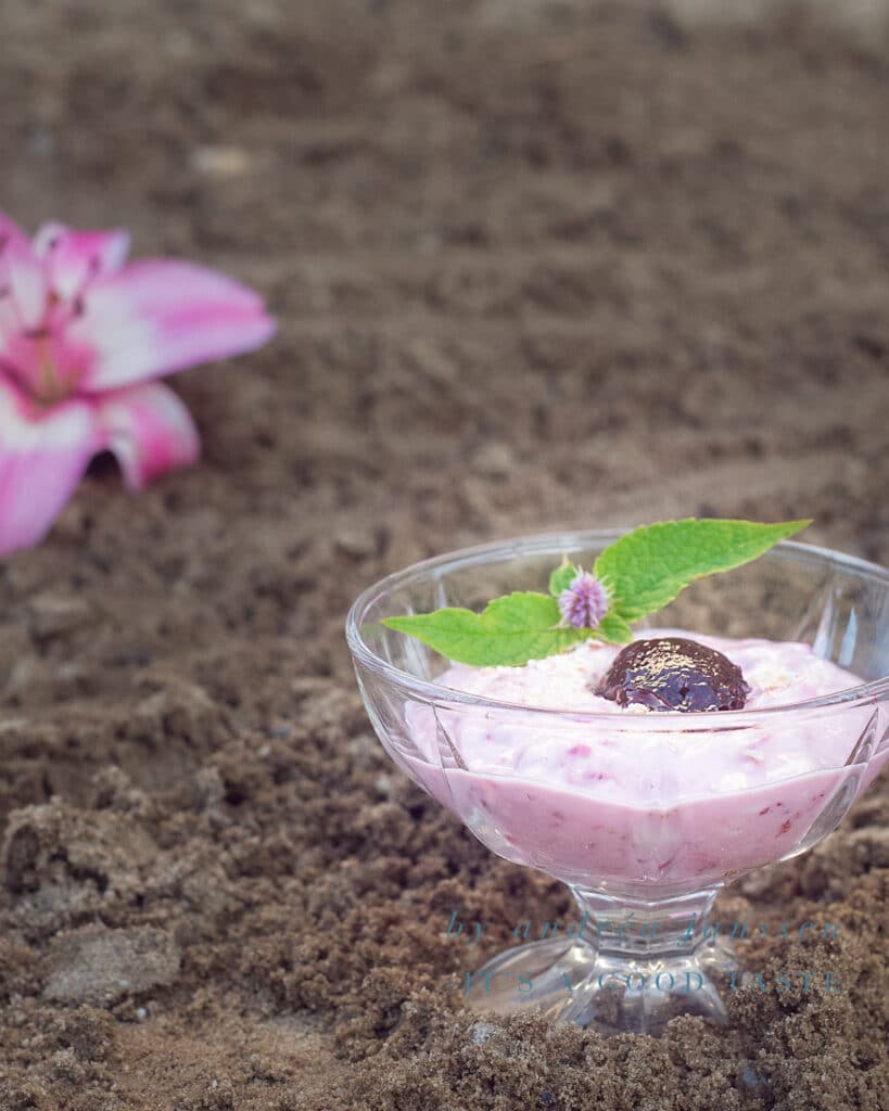 a glass of Strawberry mousse with oatmeal in the sand