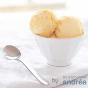 A square photo a white bowl with three scoops of Cognac ice cream and a spoon
