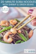 A portion of a white bowl with noodles, green beans, and shrimp. A text: easy recipe, 20-Minute Soba Noodles with Shrimp and Green Beans