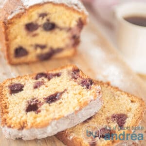 A square shot of a blueberry cake and a cup of coffee