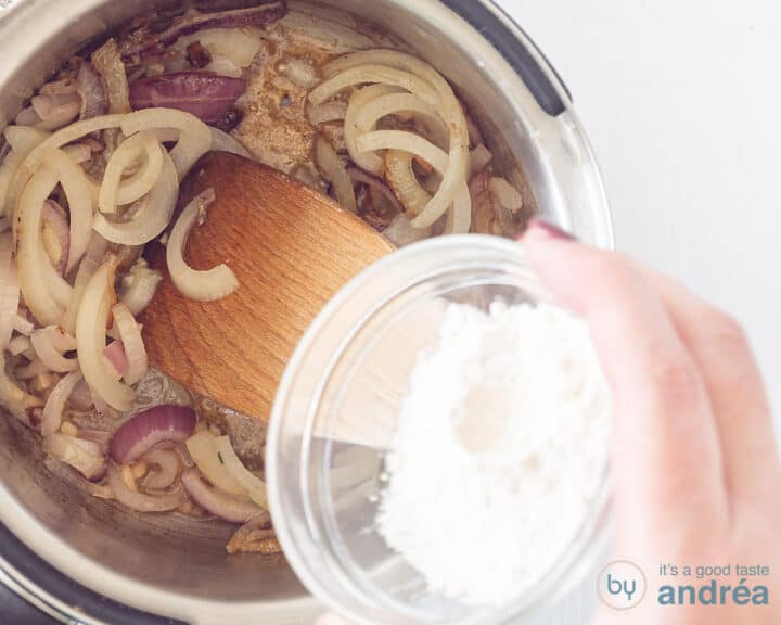 Flour is added to the saucepan with fried onion rings