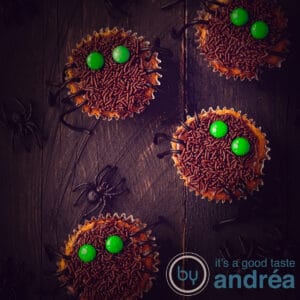 a square photo of 2 whole spider cupcakes and 2 half spider cupcakes