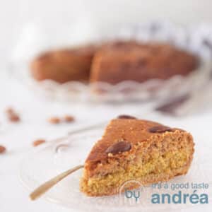 A square photo with a point filled with gingerbread. The rest of the cake in the background. A white background