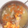 Pumpkin cubes are added to the broth.