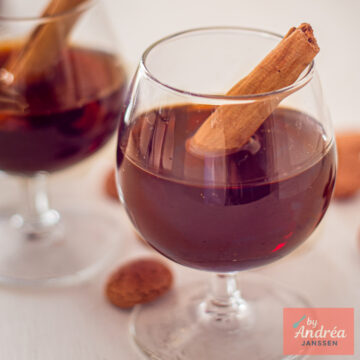 Close-up of homemade spiced liqueur served with a cinnamon stick