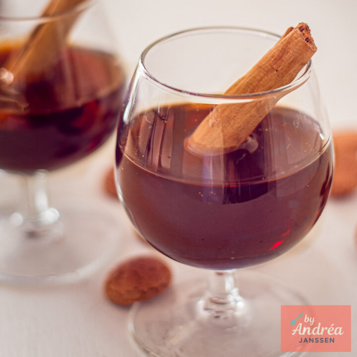 Close-up of homemade spiced liqueur served with a cinnamon stick