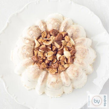 A square photo from above of pudding with gingerbread on a white plate on a white background