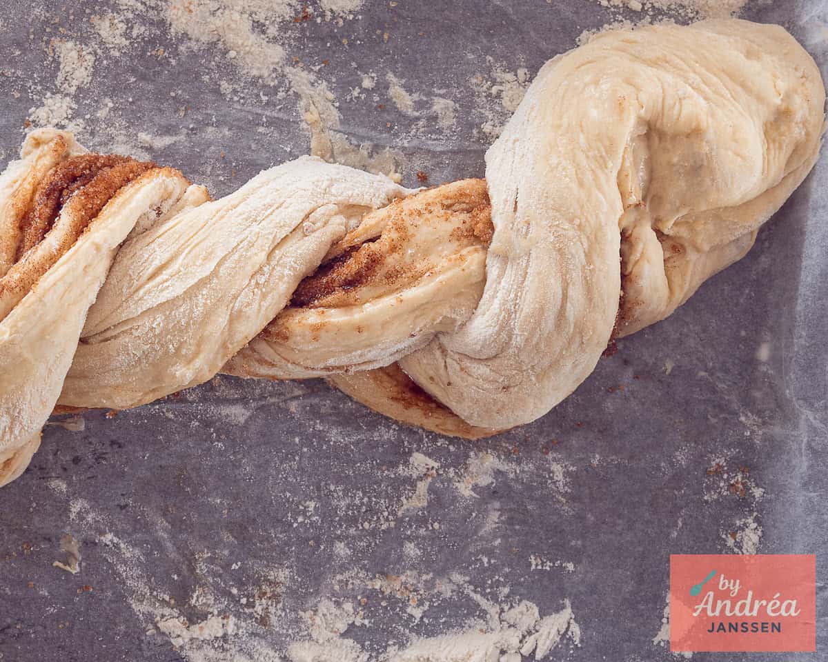 Cinnamon bread dough is breaded on a baking plate