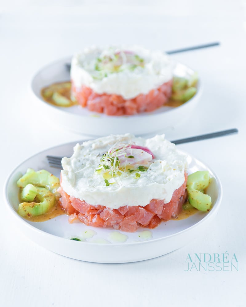 two plates with towers of smoked salmon and goat cheese