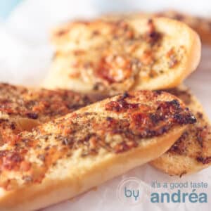 A square photos with garlic buns on a white background