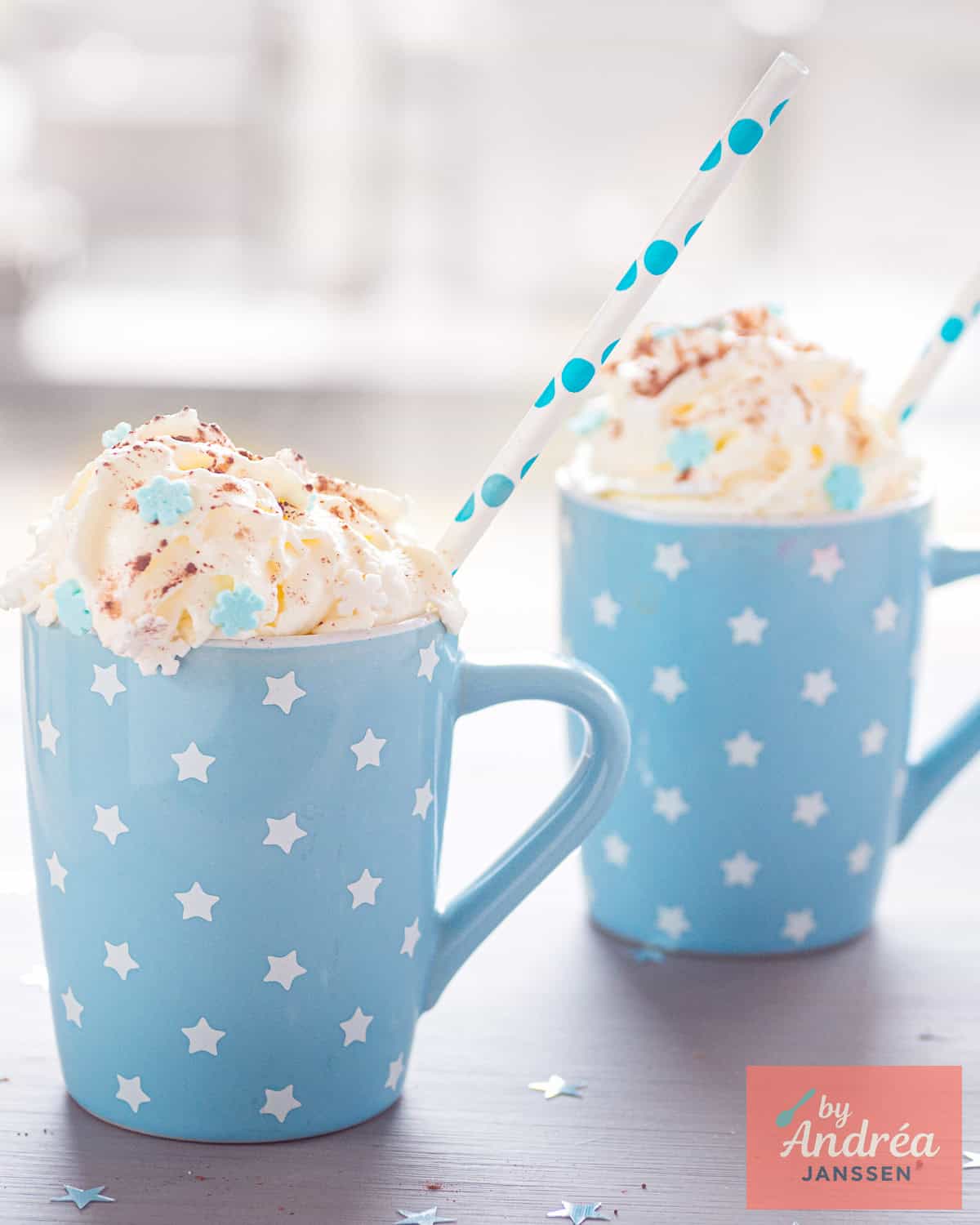 Two blue cups with baileys hot chocolate and whipped cream