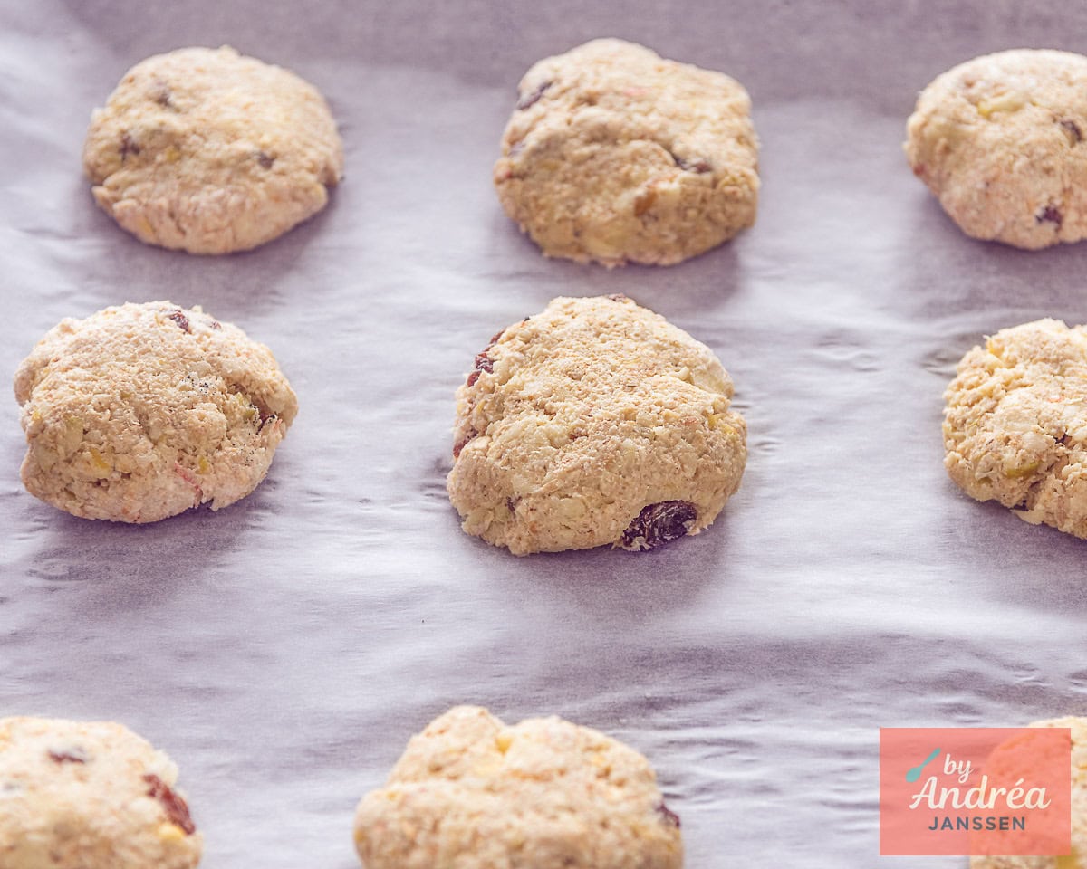 A baking sheet of unbaked oatmeal raisin cookies