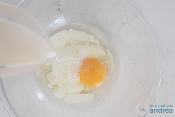 Pour milk into the batter for the pancakes